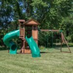 Tacoma Falls Wooden Backyard Playset & Swing Set shown in an outdoor setting