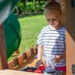 Tacoma Falls Wooden Backyard Playset & Swing Set shown in an outdoor setting