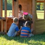 Bristol Point Wooden Backyard Playset & Swing Set shown in an outdoor setting