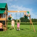 Belmont Wooden Backyard Playset & Swing Set shown in an outdoor setting