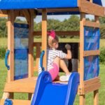 Aurora Wooden Backyard Playset & Swing Set shown in an outdoor setting