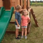 Echo Heights Wooden Kids' Backyard Playhouse shown in an outdoor setting