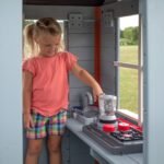 Beacon Heights Kids' Backyard Playhouse shown in an outdoor setting