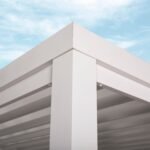 Windham Modern Steel 14 ft. x 10 ft. Pergola with Sail-Shade Canopy shown in an outdoor setting