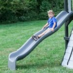 Whispering Point Wooden Backyard Playset & Swing Set shown in an outdoor setting