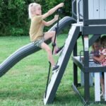 Whispering Point Wooden Backyard Playset & Swing Set shown in an outdoor setting
