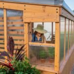 Zalie 12 ft. x 7 ft. Wood Backyard Greenhouse Kit shown in an outdoor setting