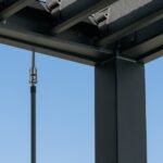 Sarasota 12 ft. x 10 ft. Steel Louvered Patio Pergola shown in an outdoor setting