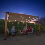 Brendan 12 ft. x 10 ft. Pergola with Sail-Shade Canopy shown in an outdoor setting
