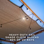 Brendan 12 ft. x 10 ft. Pergola with Sail-Shade Canopy shown in an outdoor setting