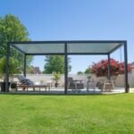 Sarasota 20 ft. x 10 ft. Steel Louvered Patio Pergola shown in an outdoor setting