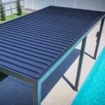 Sarasota 20 ft. x 10 ft. Steel Louvered Patio Pergola shown in an outdoor setting