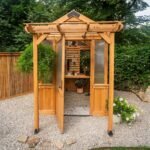 Bellerose 9 ft. x 6 ft. Wood Backyard Greenhouse Kit shown in an outdoor setting