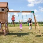 Montpelier Wooden Backyard Playset & Swing Set shown in an outdoor setting