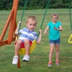 Oakmont Wooden Backyard Playset & Swing Set shown in an outdoor setting