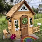 Aspen Wooden Kids' Backyard Playhouse shown in an outdoor setting