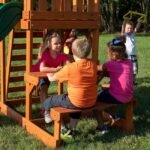 Tucson Wooden Backyard Playset & Swing Set shown in an outdoor setting