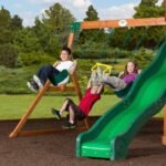 Shenandoah Wooden Backyard Playset & Swing Set shown in an outdoor setting