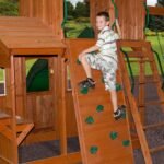 Shenandoah Wooden Backyard Playset & Swing Set shown in an outdoor setting