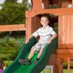 Shenandoah Wooden Backyard Playset & Swing Set shown in an outdoor setting