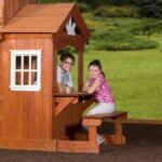 Shenandoah Wooden Backyard Playset & Swing Set shown in an outdoor setting