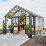 Backyard Discovery Larkspur 14 x 12 greenhouse with people for scale